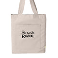 Beige tote bag with 'Stow & Roam' text on a white background